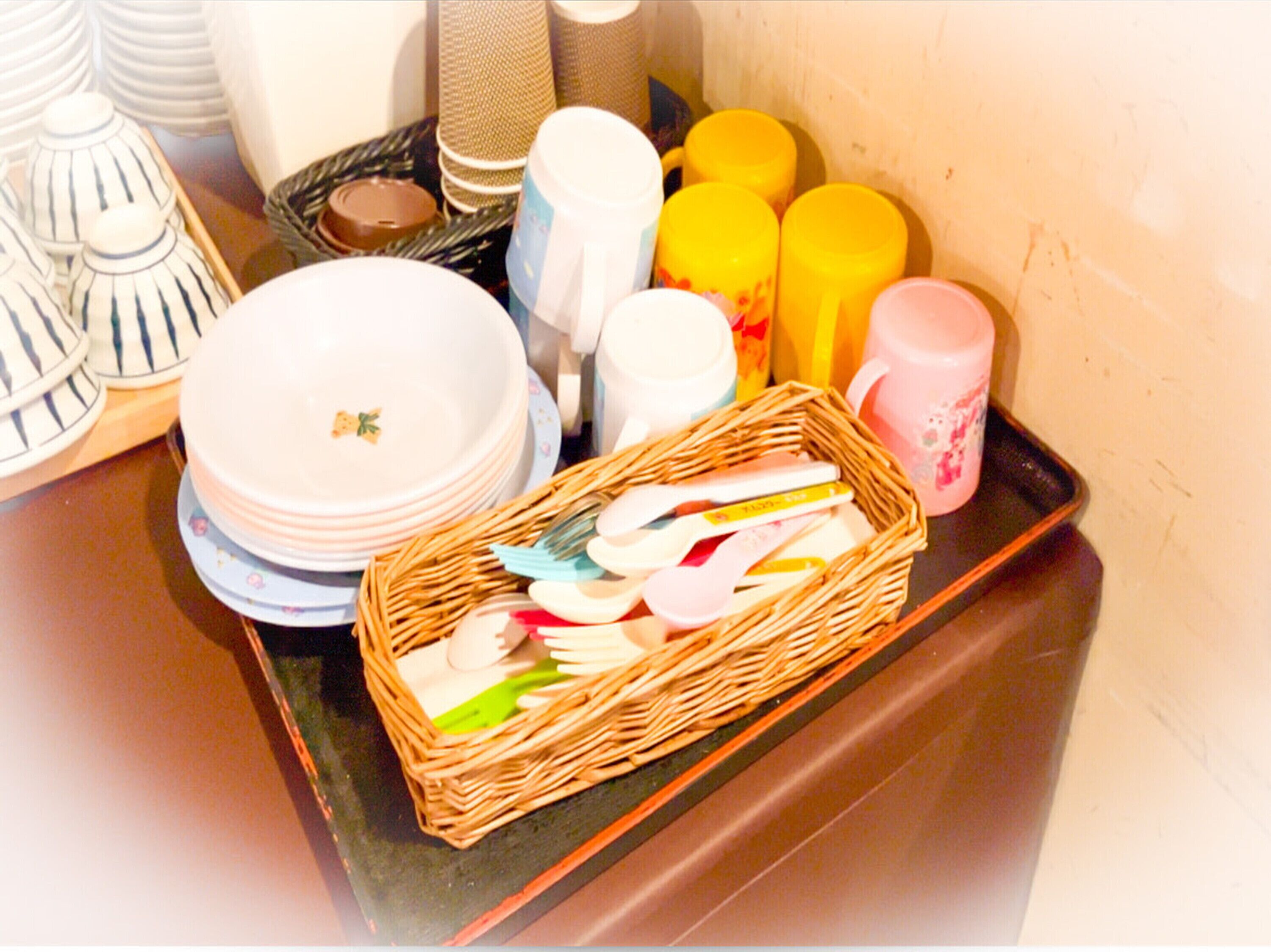 A tray with various kitchen items including plates, bowls, and utensils.