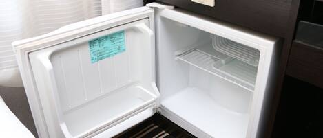 An open refrigerator with a control panel and a note on the door.