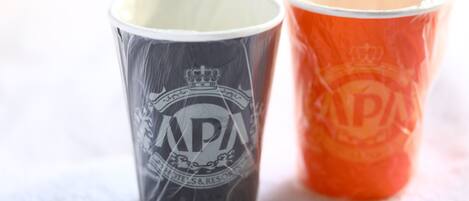 Deux tasses, l’une avec un logo et du texte, l’autre avec un logo et du texte.