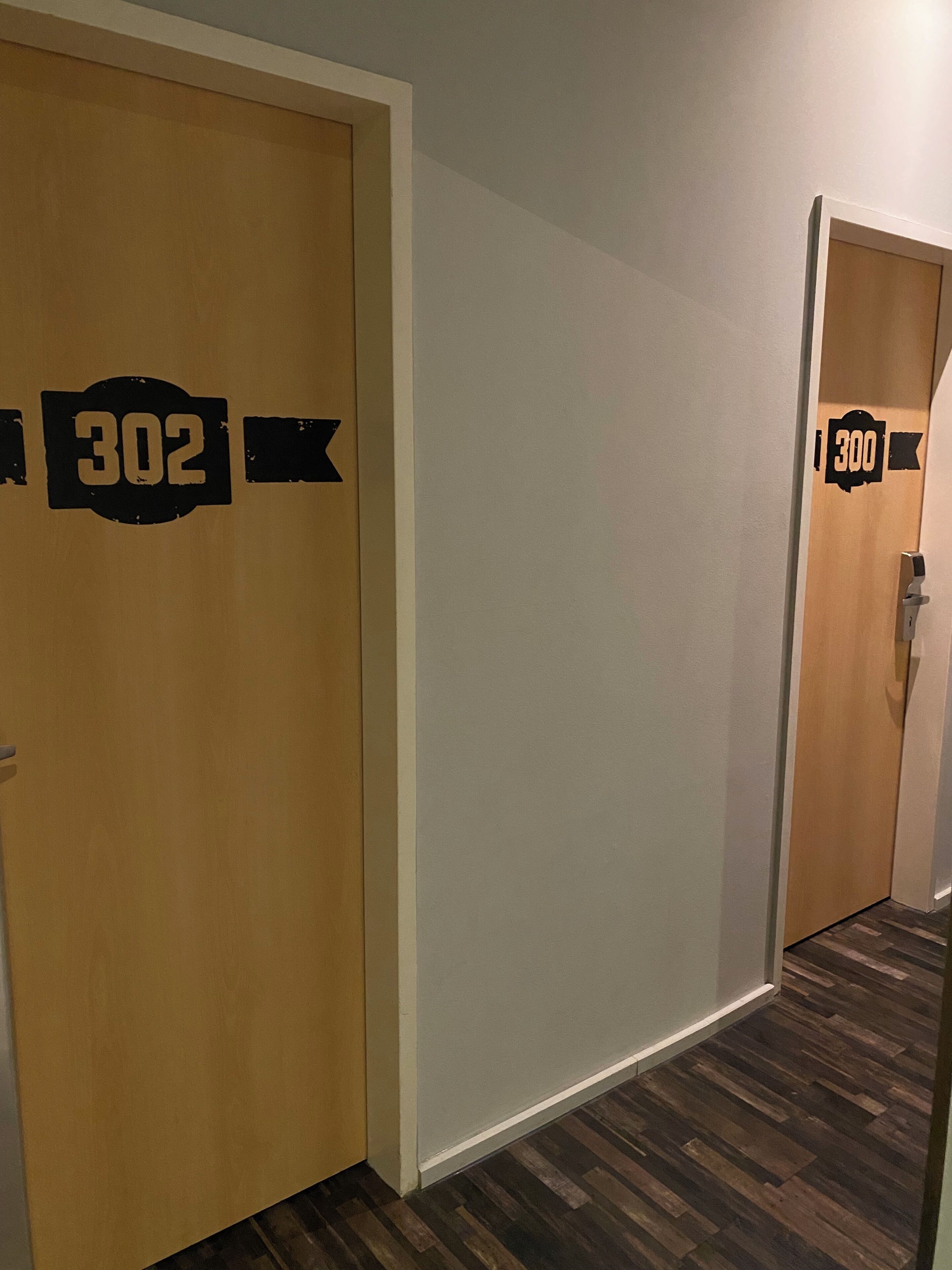 A hallway with two doors, each marked with a number.