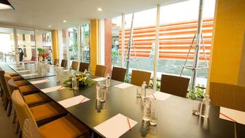 A conference room with a long table, chairs, and water bottles.