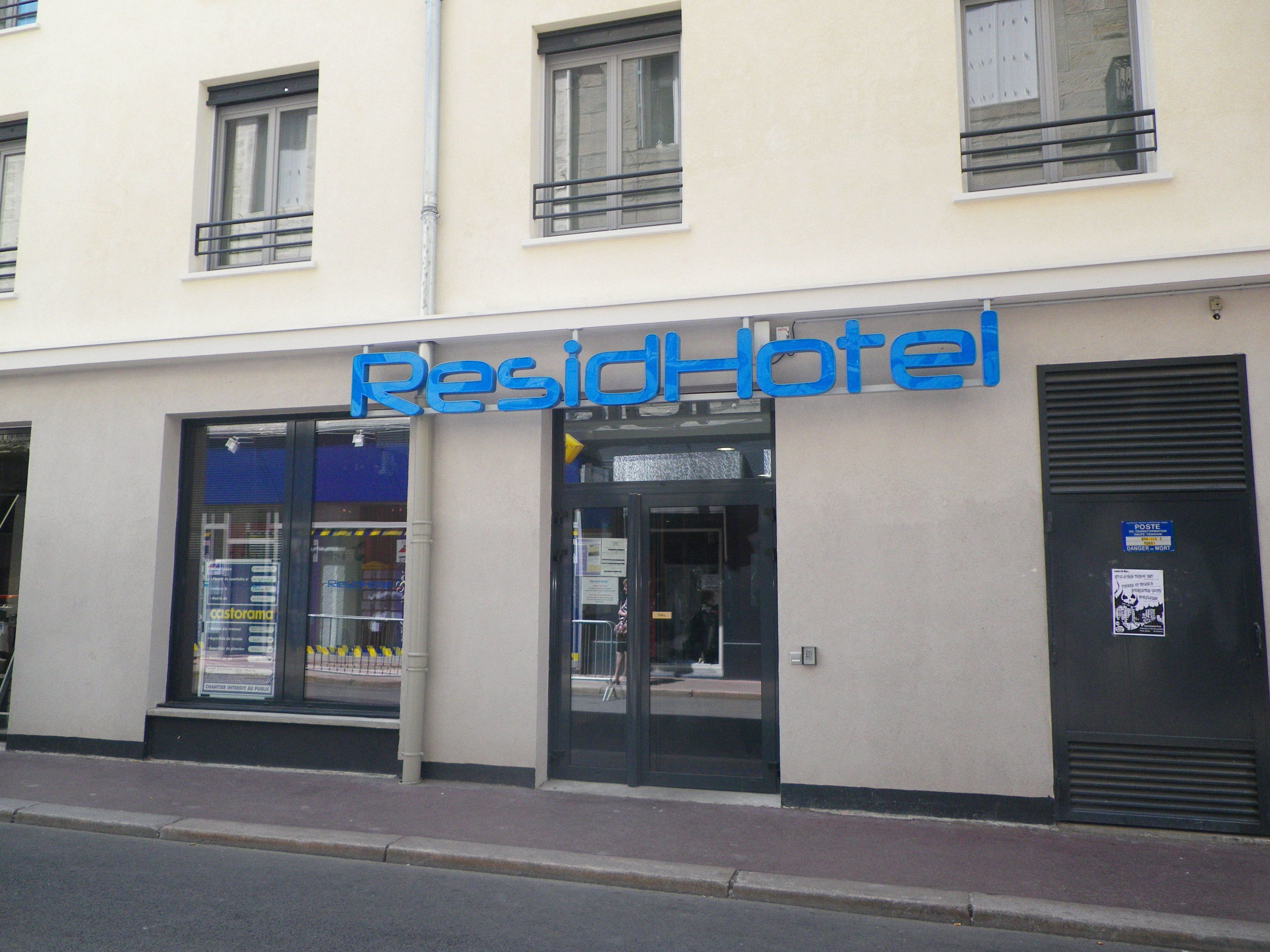 A building with a sign reading "ResiHotel."