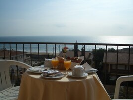 Tavola imbandita per la colazione con vista sull'oceano.