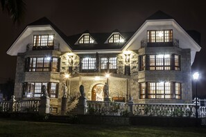 A large, multi-story house with a stone facade, multiple windows, and a balcony. - Hotel Antoyana (Santander)