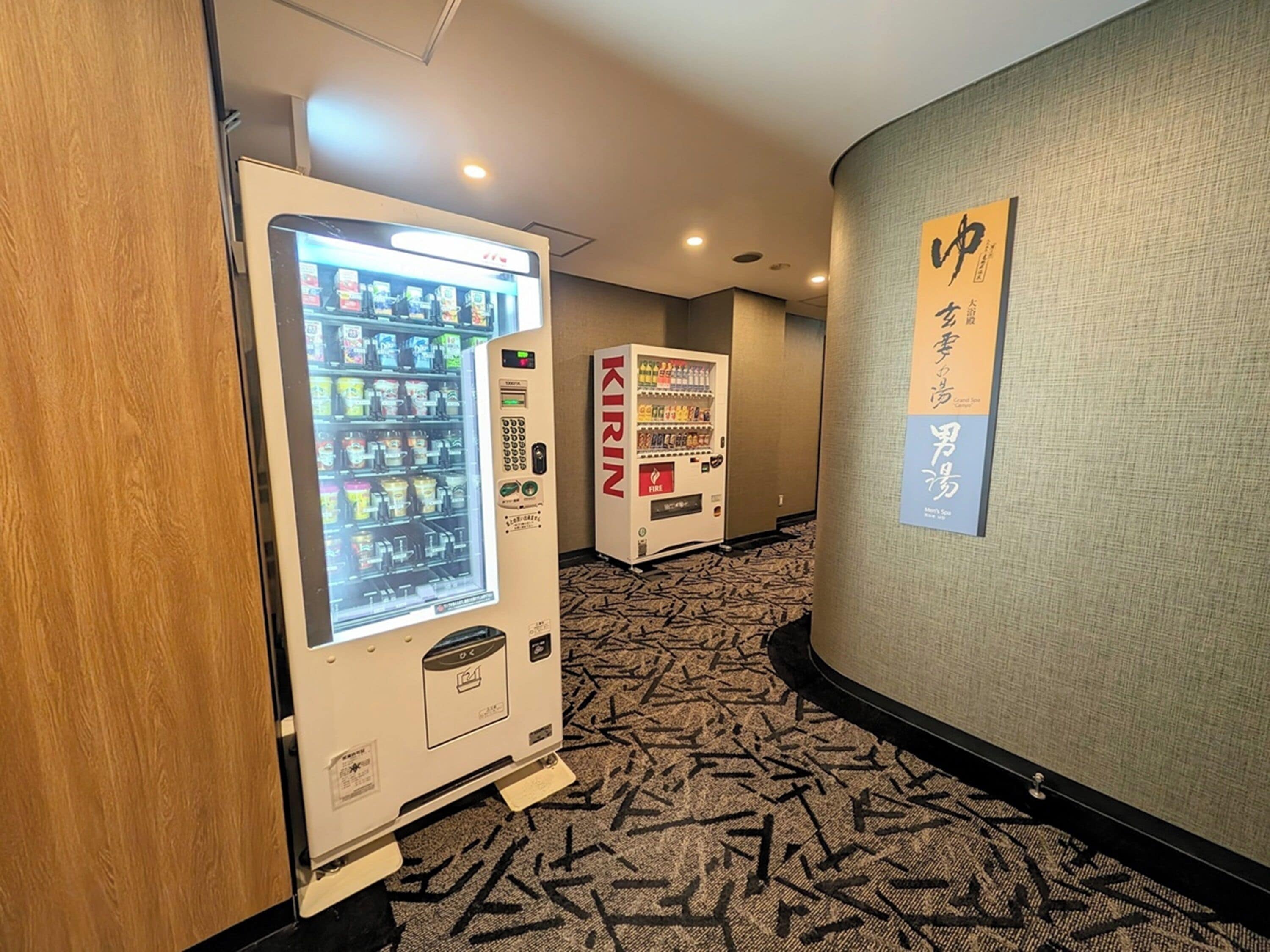 A hallway with vending machines and a sign on the wall.