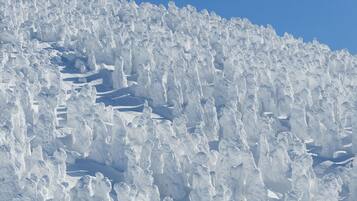 A snow-covered mountain with a clear sky.