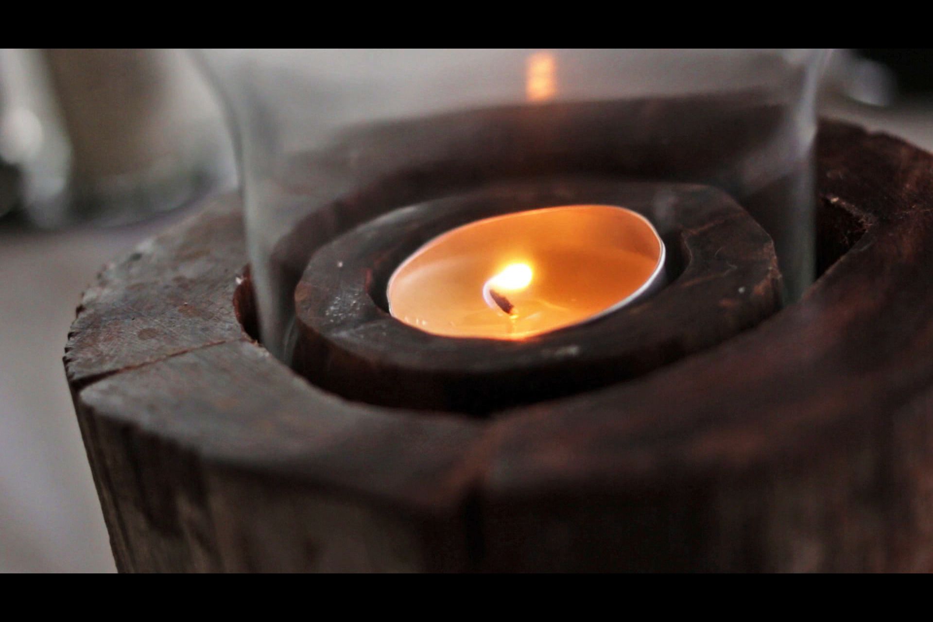 A close-up of a candle in a glass holder.