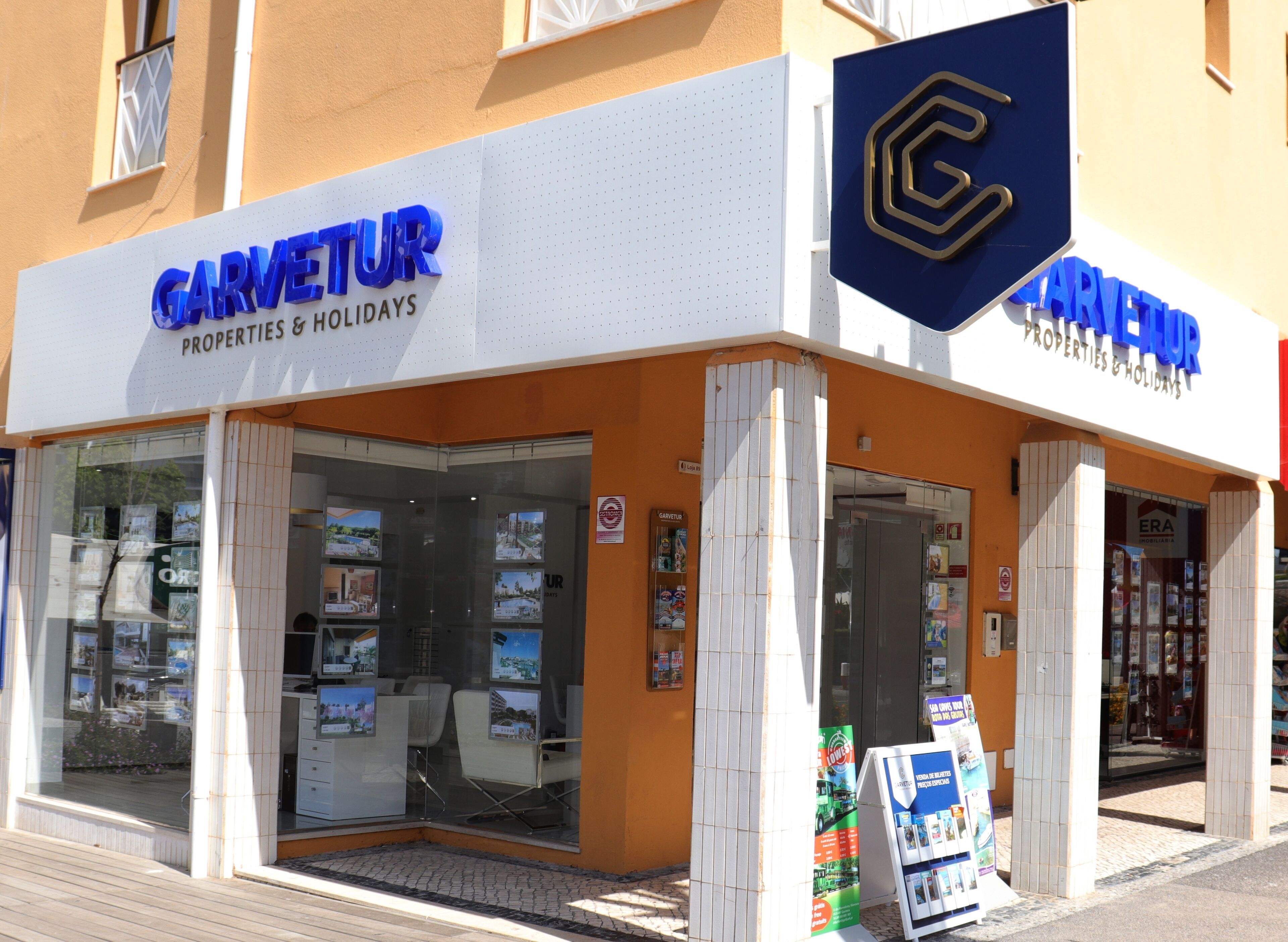 A storefront with a sign reading "GARVETUR PROPERTIES & HOLIDAYS".