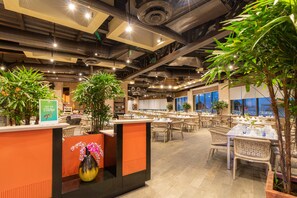A restaurant with indoor plants, tables set for dining, and a modern industrial ceiling design. - Villa del Palmar Cancun Luxury Beach Resort & Spa (Punta Sam)