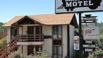 Experience the charm of RAILTOWN MOTEL, featuring a traditional pitched roof and a second-floor balcony.