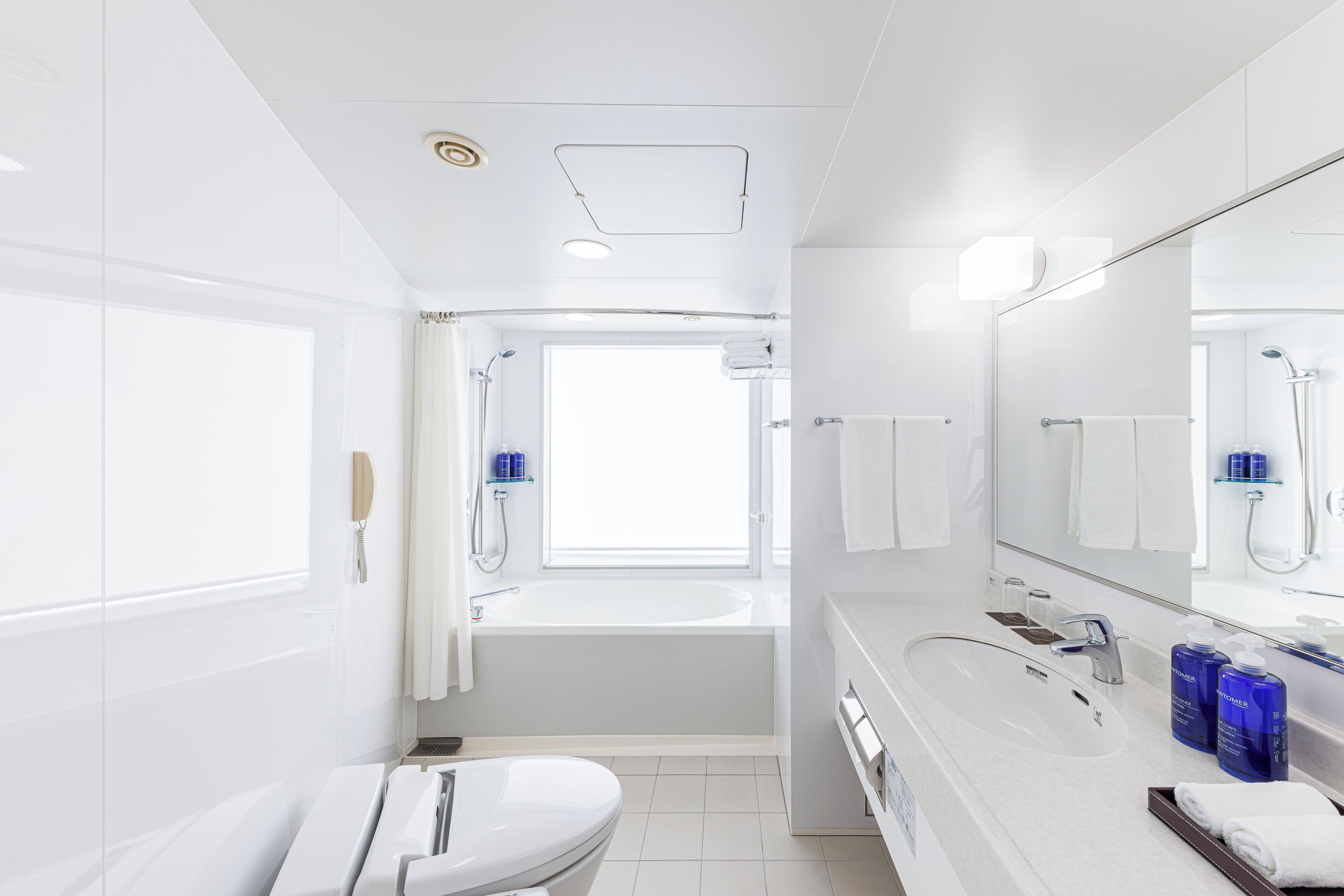 Combined shower/tub, designer toiletries, hair dryer, slippers