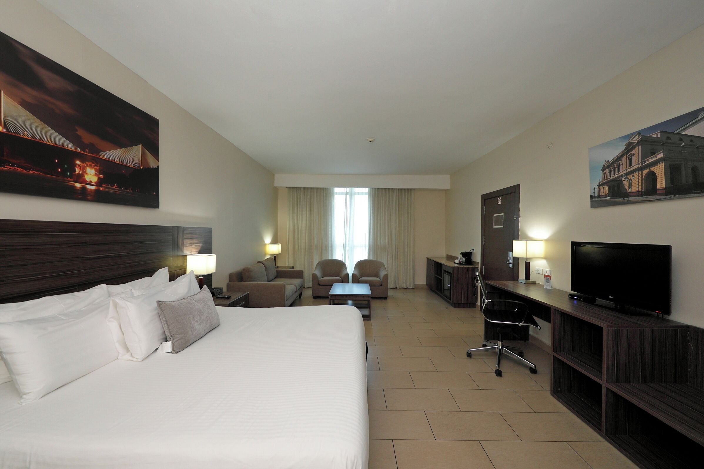 executive double room, 1 king bed | living area | flat-screen tv, ipod dock