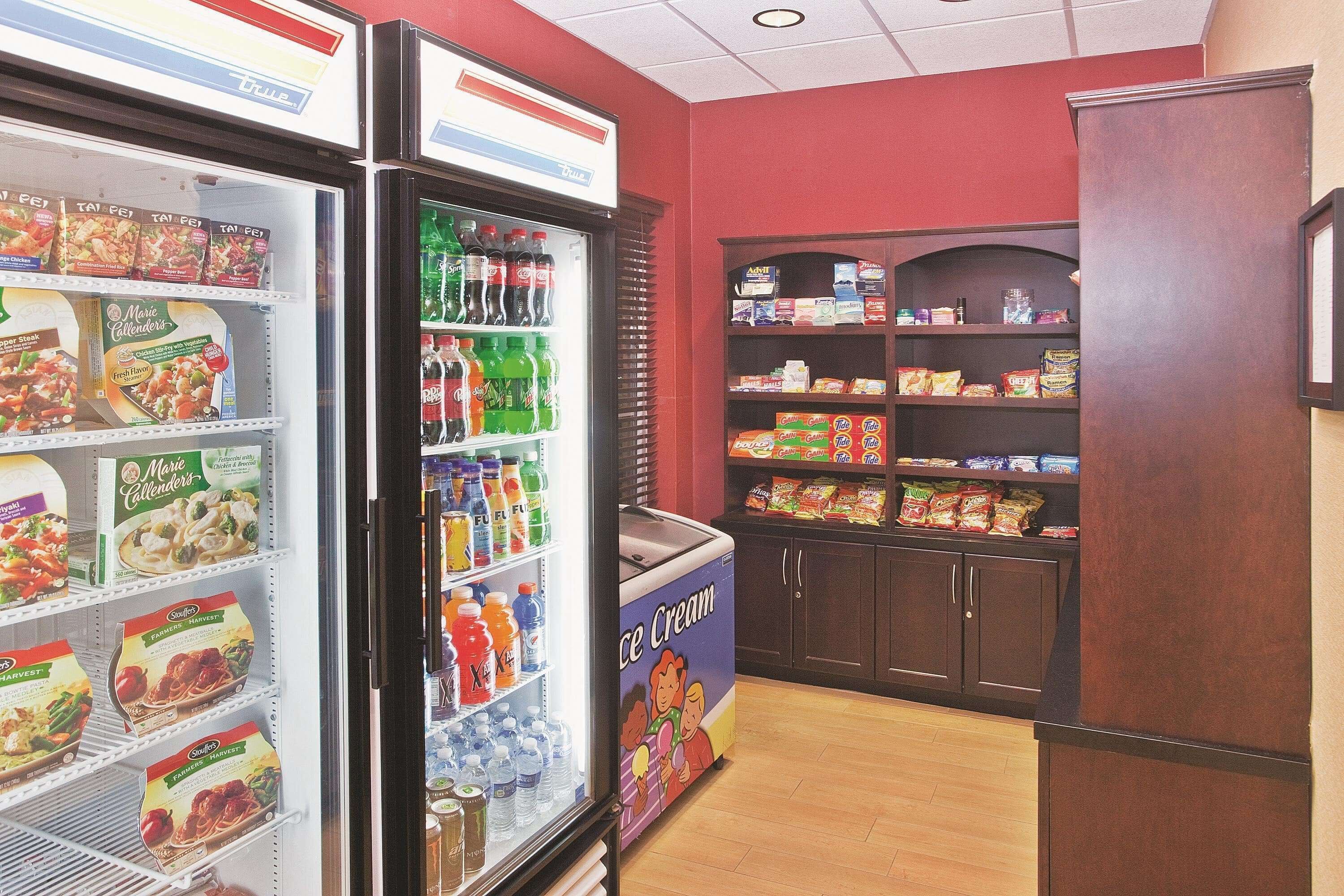 A refrigerated display with various food items and beverages.