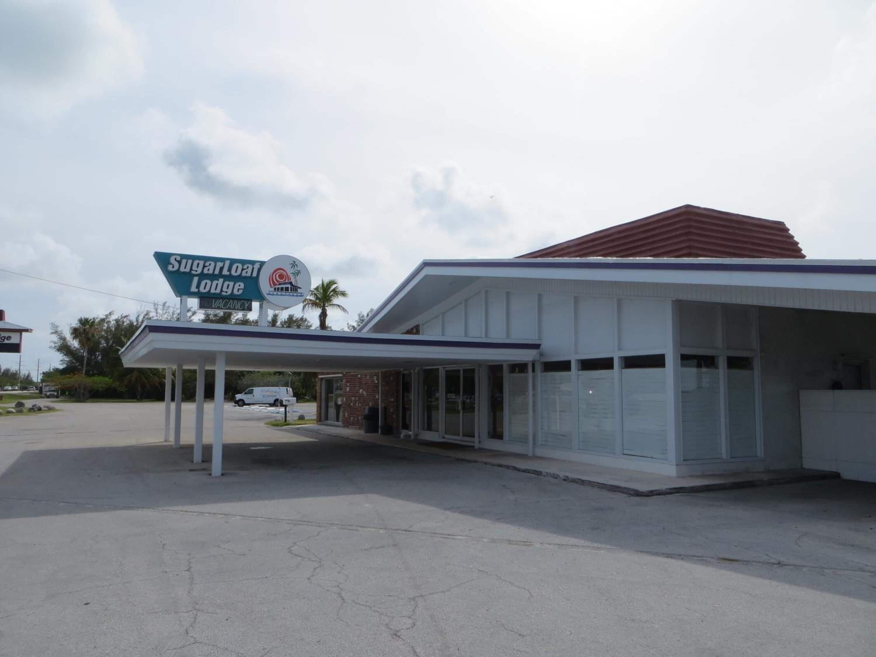 A building with a covered entrance and a sign for 'Sugarloaf Lodge' indicating a vacation rental.