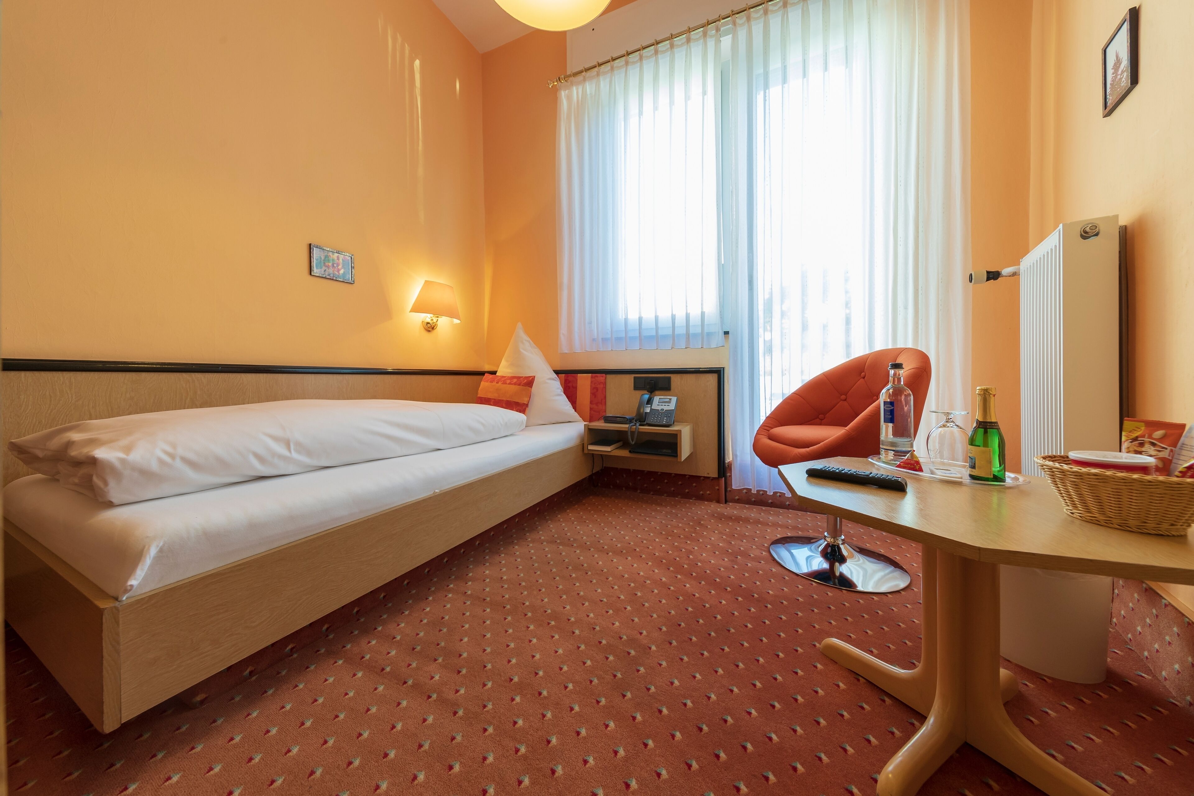 deluxe single room (haupthaus) | in-room safe, desk, blackout curtains, iron/ironing board