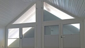 A room with a sloped ceiling and skylights, providing natural light. - Gästehaus Alba (Rust)