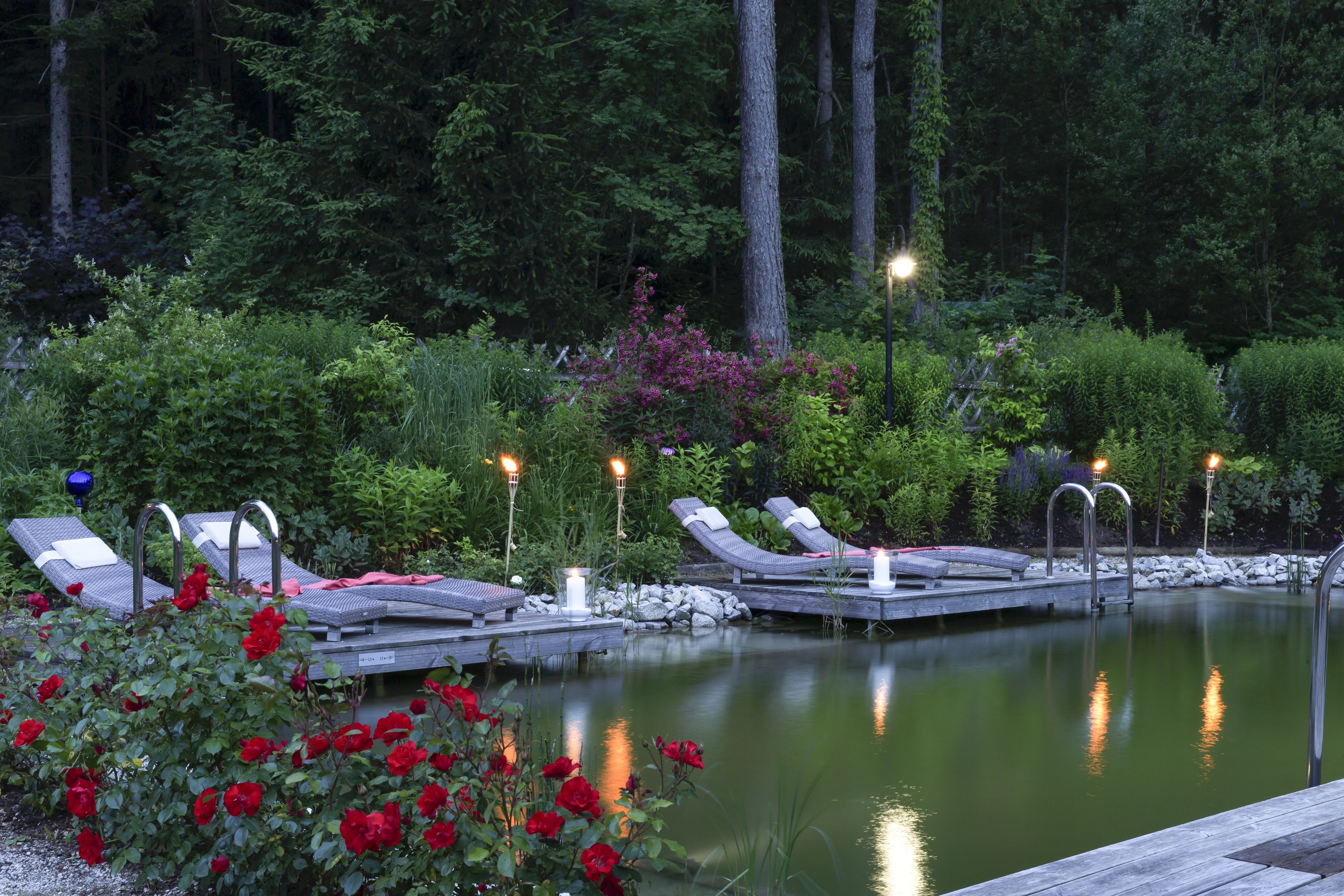 outdoor pool, a natural pool, pool loungers