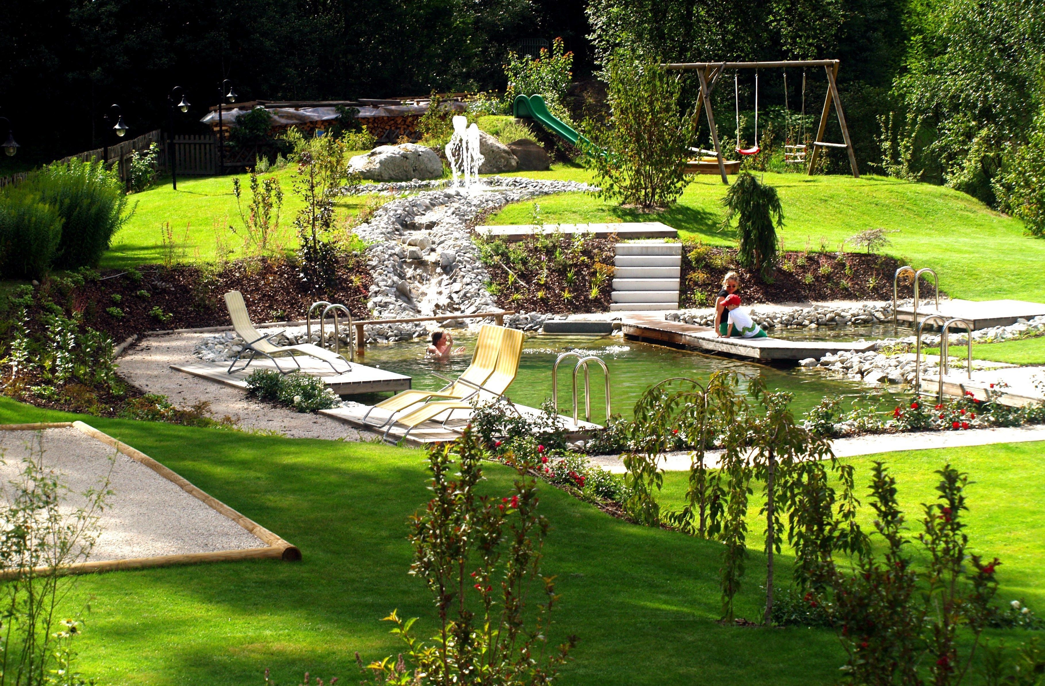 outdoor pool, a natural pool, pool loungers