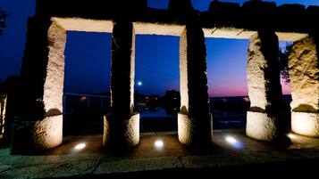 A stone structure with columns at twilight.