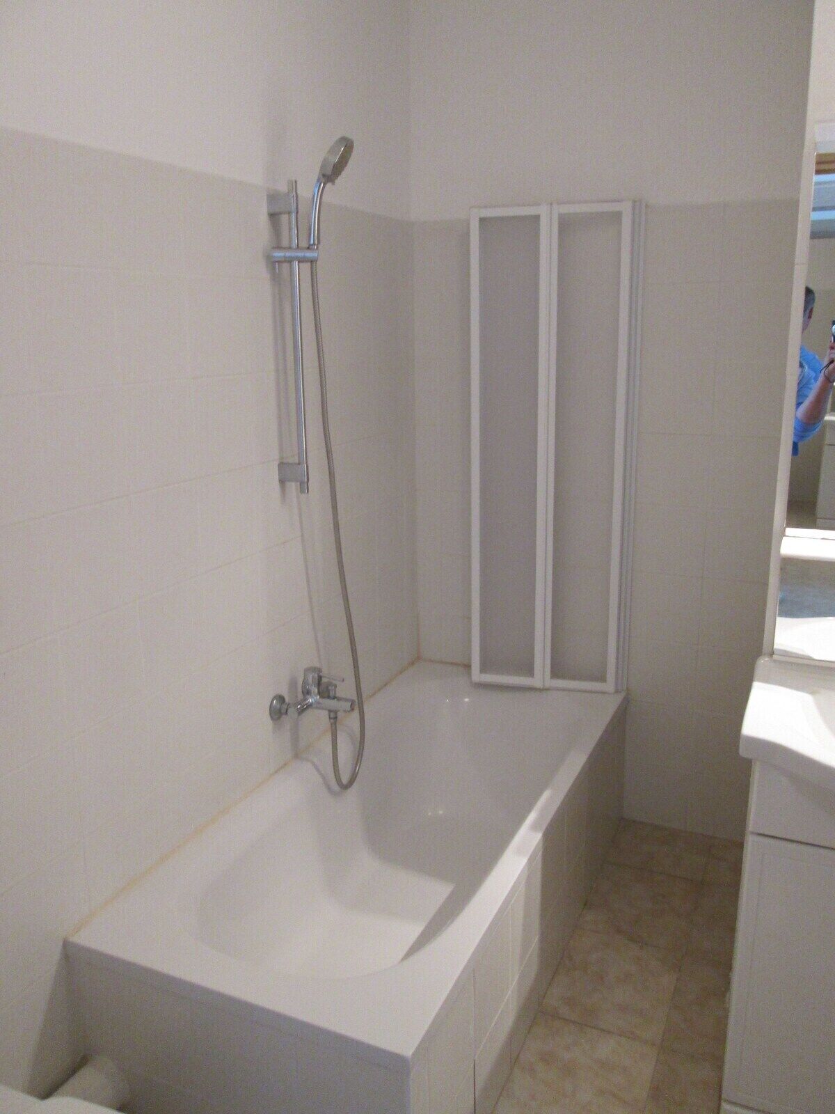 A bathroom with a bathtub, a shower, and a toilet.
