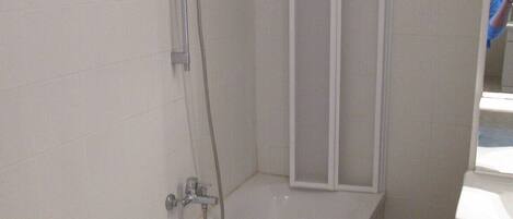 A bathroom with a bathtub, a shower, and a toilet.