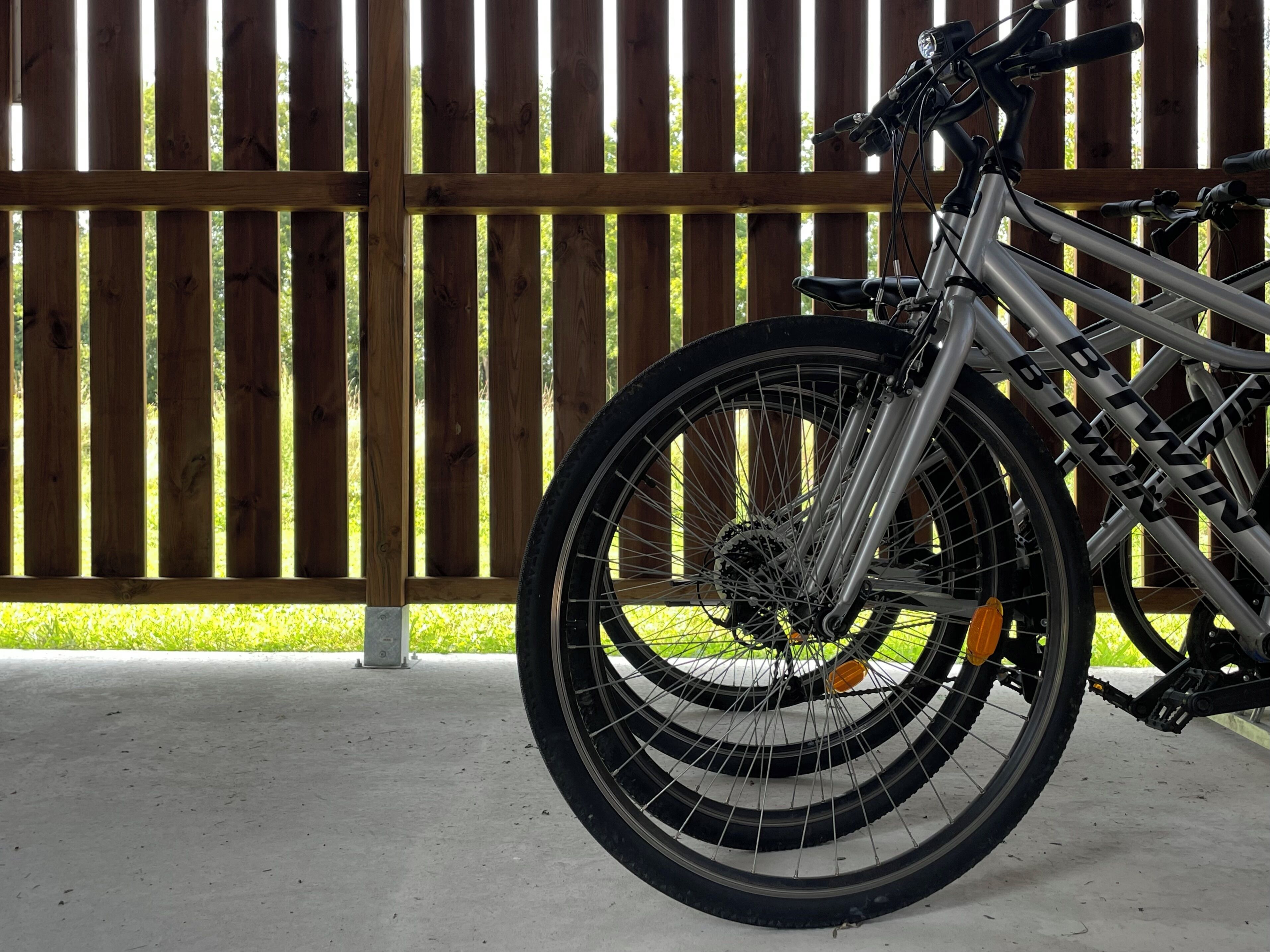 Una bicicleta estacionada frente a una valla de madera.