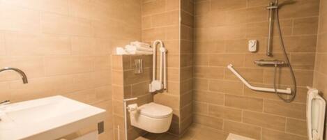 A modern bathroom with a sink, toilet, and shower.