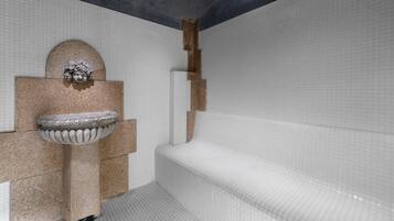 Bathroom features a sink, wall-mounted mirror, and large bathtub.