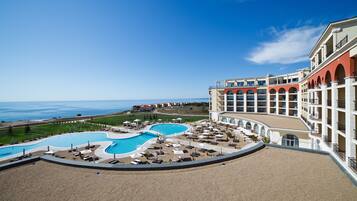 Relax by the resort's two pools, overlooking the ocean.