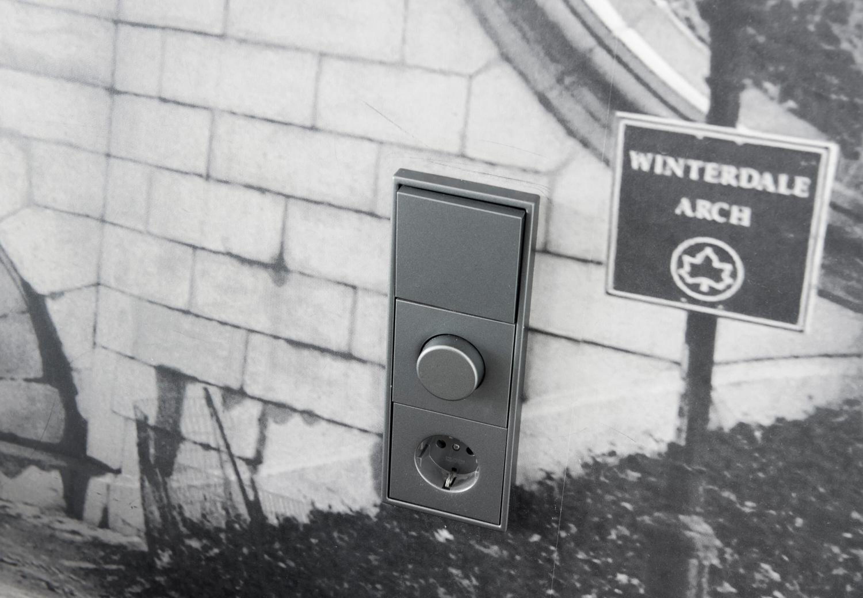 A wall-mounted electrical box with a sign reading "WINTERDALE ARCH".