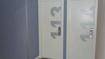 A room with two white doors, each marked with a number.