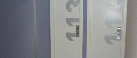 A room with two white doors, each marked with a number.