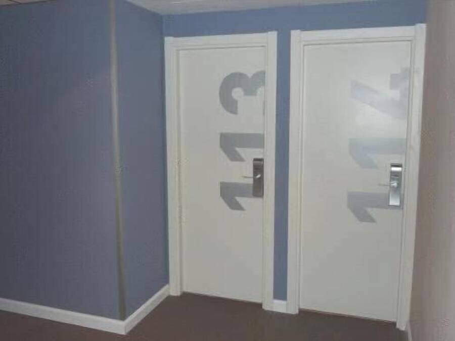 A room with two white doors, each marked with a number.