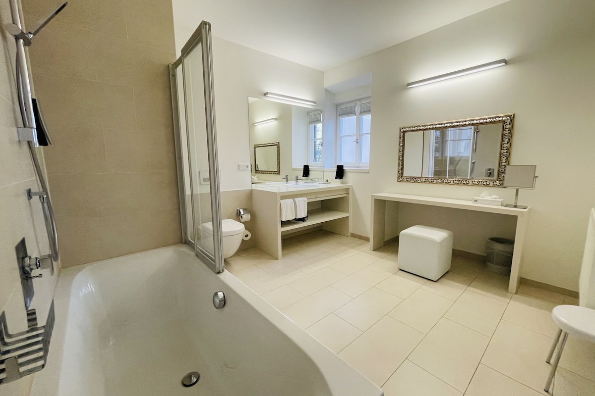 deluxe room | bathroom | shower, free toiletries, hair dryer, bathrobes