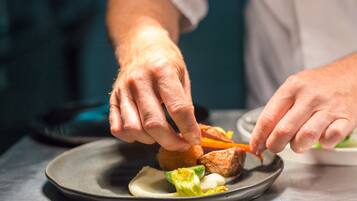 A person serving food on a plate.