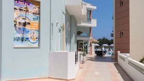 A building named ATHENA with a swimming pool and snack bar sign. - Athena Apartments (Hersonissos)