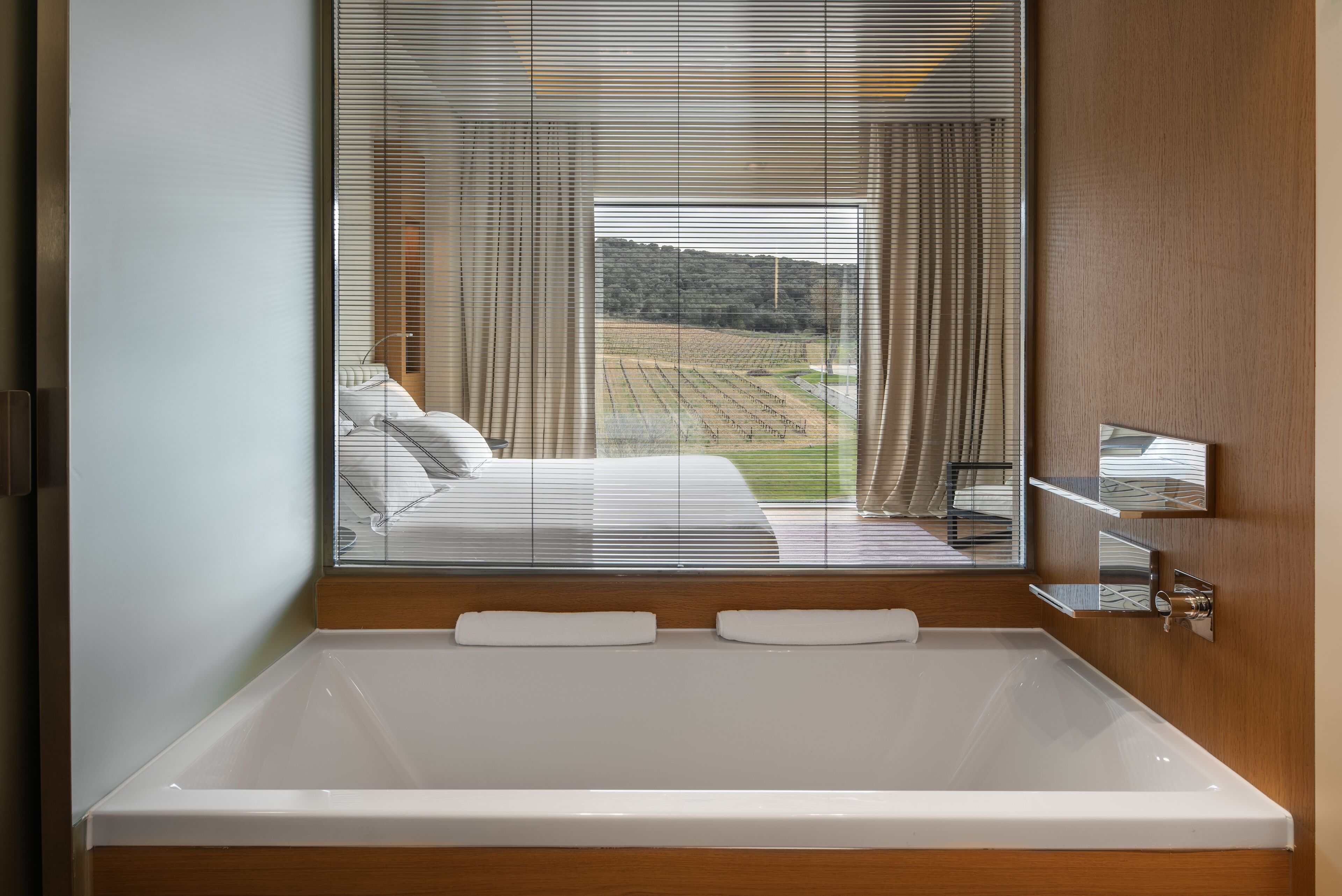 separate bathtub and shower, rainfall showerhead, designer toiletries