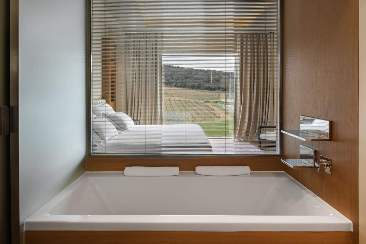 separate bathtub and shower, rainfall showerhead, designer toiletries