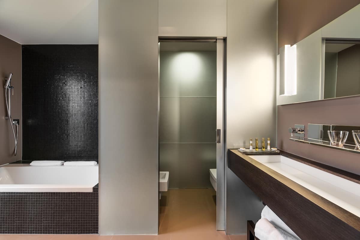 deluxe suite (royal) | bathroom | separate bathtub and shower, rainfall showerhead, designer toiletries