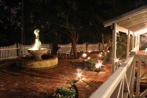 A brick pathway leading to a fountain with a statue, surrounded by a white picket fence and trees. - Rosebridge House Bed & Breakfast Adult Retreat (Gooseberry Hill)