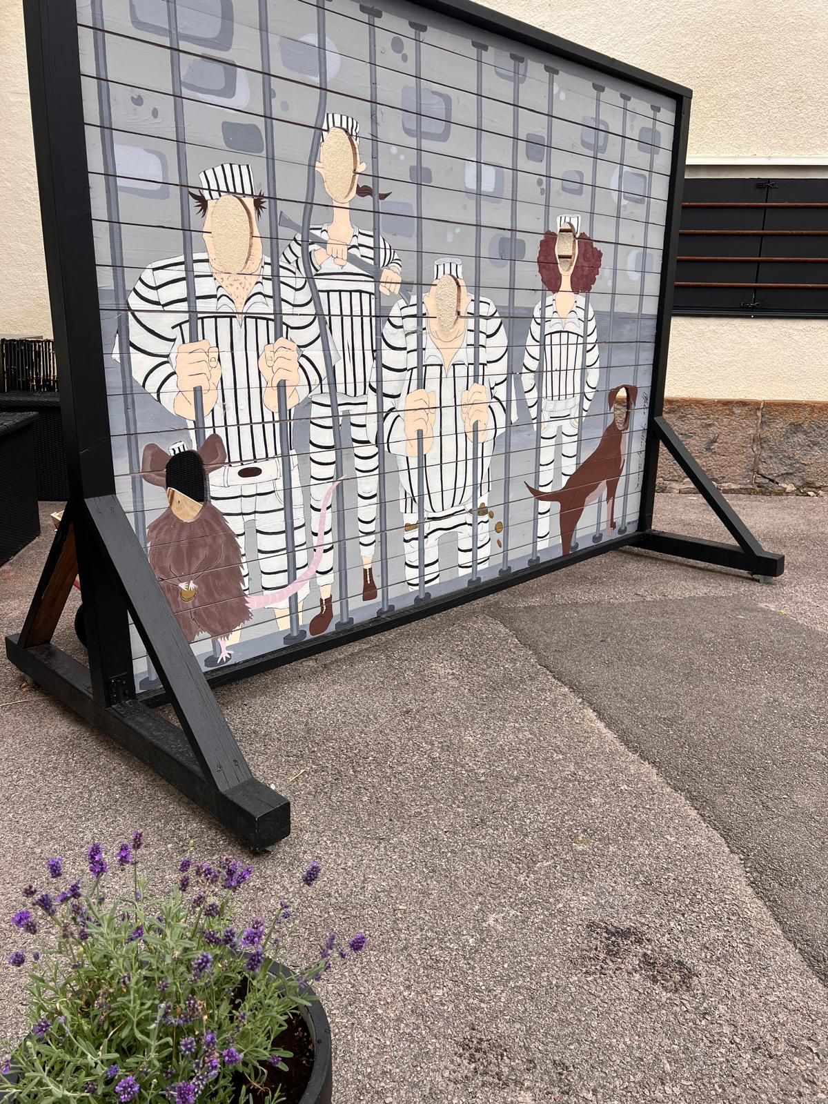 A metal gate with a grid pattern and a black frame.