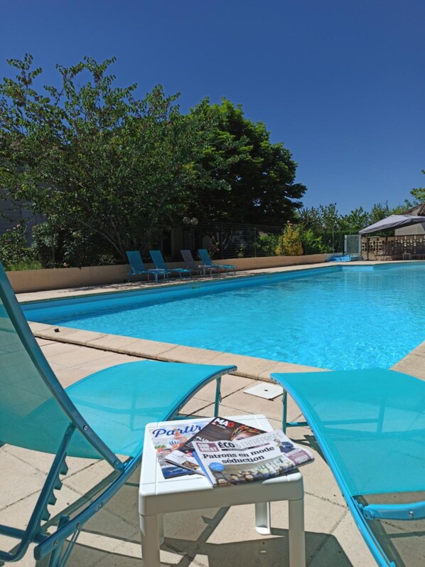 Seasonal outdoor pool, open 10:00 AM to 9:00 PM, pool umbrellas