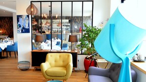 A modern interior with a yellow armchair, a grey sofa, and a blue floor lamp. - Logis Hotel et Restaurant Le Galion Canet Plage (Canet-en-Roussillon)