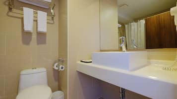 A modern bathroom with a toilet, sink, and shower.