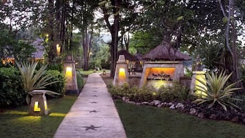 A pathway leading to a pool area with a sign indicating 'Pool Villa Club'.
