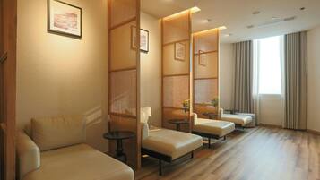 Relax in a stylish room with seating areas, a wooden floor, and large windows.