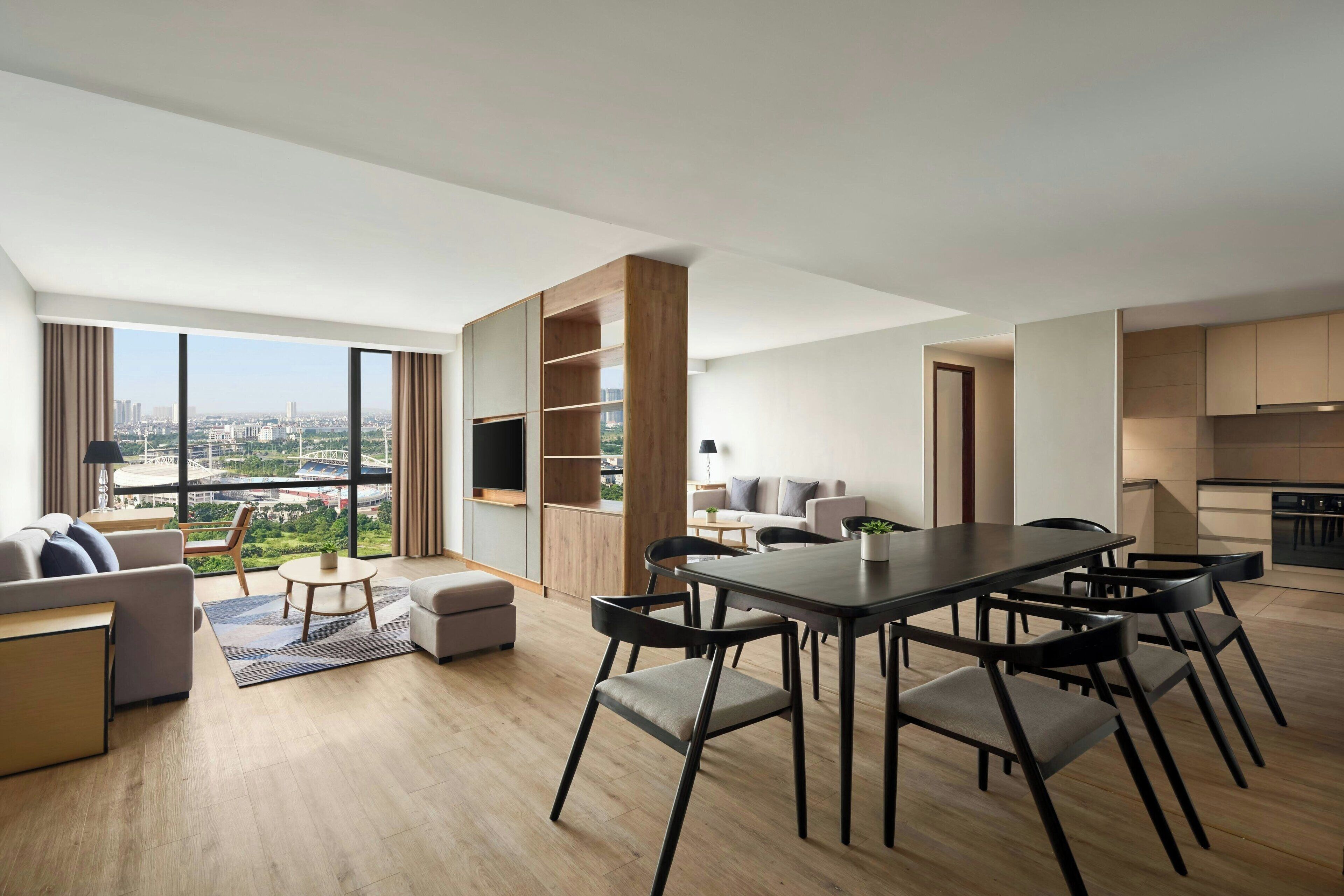 Un appartement moderne comprenant un coin repas, une cuisine et un salon.