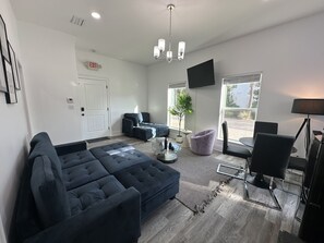 Elite Quadruple Room | Living area | 55-inch Smart TV with digital channels, Netflix, streaming services