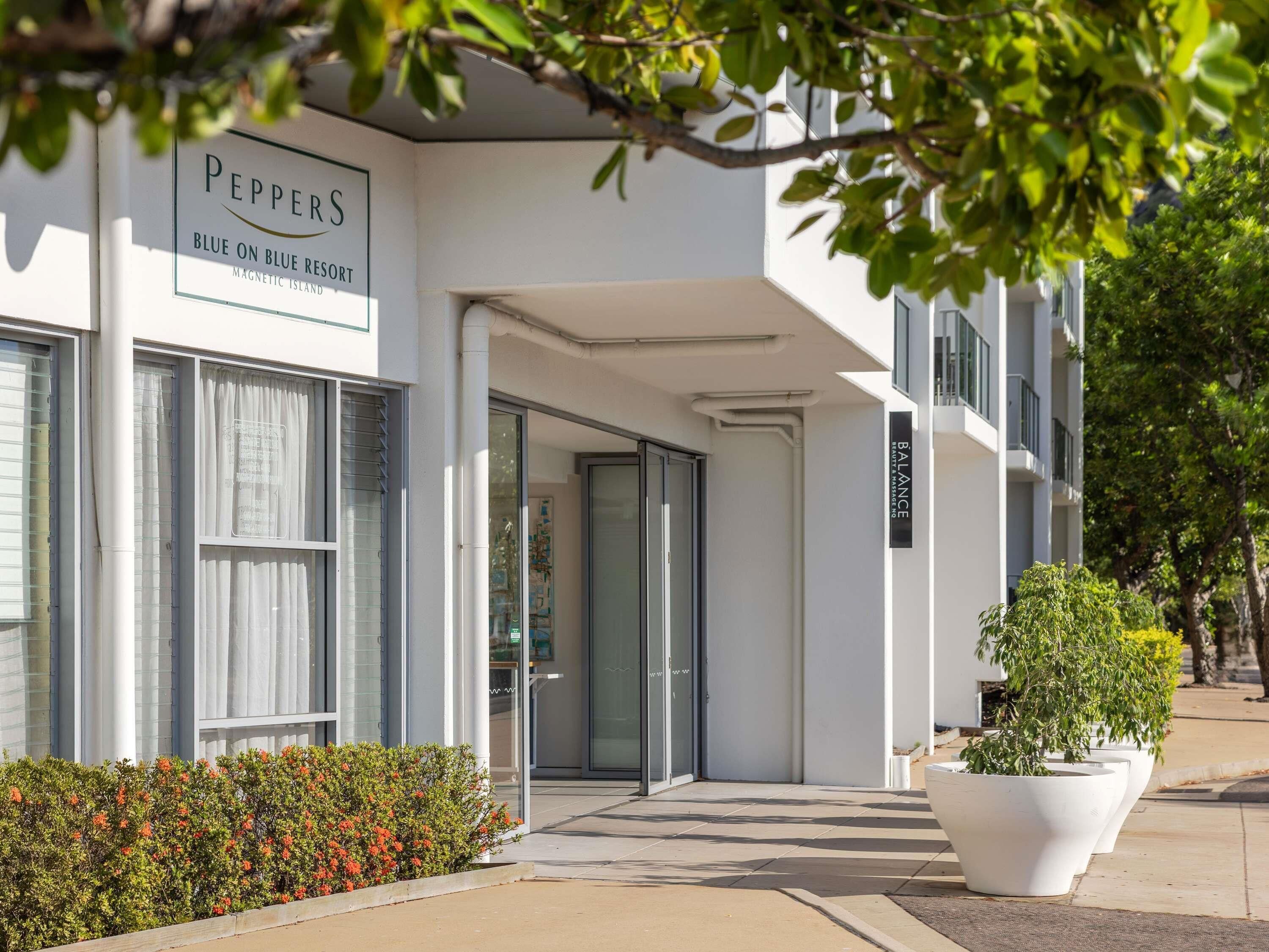 A modern building with a sign reading 'Peppers Blue on Blue Resort Magnetic Island.'