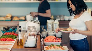 A buffet setup with various food items and condiments. - Biz Apartment Gärdet (Stockholm)